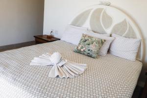 a white bed with a white bow on it at Ocean Views Pool 2 Bedroom in Los Barriles +17 photos