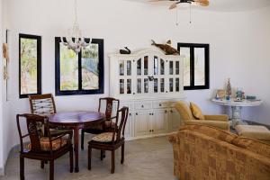 a living room with a couch and a table and chairs at Ocean Views Pool 2 Bedroom in Los Barriles
