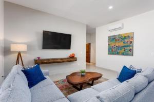 a living room with two blue couches and a table at Walkable Convenient in Downtown Los Barriles in Los Barriles