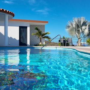 a swimming pool in front of a house at Casita GEcko in Buenavista
