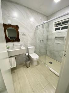 a bathroom with a shower and a toilet and a sink at The Reds Pousada in Penha +40 photos
