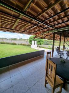 a patio with a table and chairs under a pergola at Cabana do Parque in Presidente Figueiredo