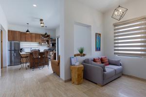 a living room with a couch and a kitchen at Seize the Day at Carpe Diem Condo in Los Barriles