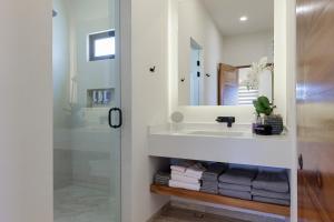 a bathroom with a sink and a shower with towels at Seize the Day at Carpe Diem Condo in Los Barriles +17 photos