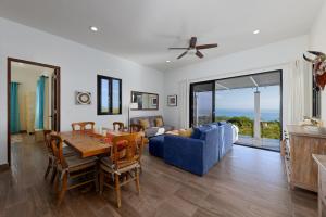 a living room with a table and a blue couch at Pool with a View in Buena Vista in Buenavista