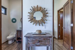 a bathroom with a mirror on the wall next to a toilet at Pool with a View in Buena Vista in Buenavista +22 photos