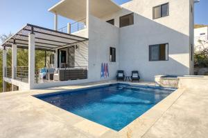 a swimming pool in front of a house at Pool with a View in Buena Vista in Buenavista