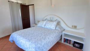 a bedroom with a bed with a blue comforter at Ocean view casita in Palo Blanco in Los Barriles