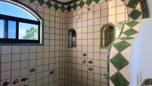 a bathroom with a shower with a window at Ocean view casita in Palo Blanco in Los Barriles