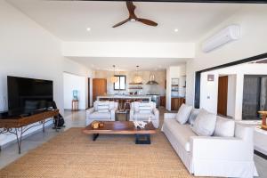 a living room with a couch and a table at Stunning Home with Incredible Views in Los Barriles