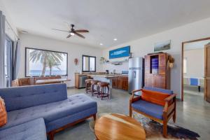 a living room with a couch and a kitchen at Beachfront Pool, Rooftop Views & Baja Sunrise in Pescadero