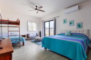 a bedroom with a bed and a desk at Beachfront Pool, Rooftop Views & Baja Sunrise in Pescadero +47 photos