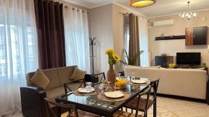 a living room with a table and a couch at Complex Summer Memories Souzan in Keramoti