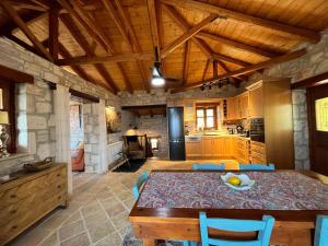 a dining room with a table and a kitchen at Villa Ionis in Volímai