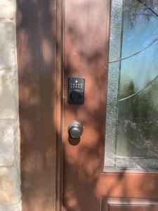 a wooden door with a door knob and a window at The Cross Patio Retreat in Buda