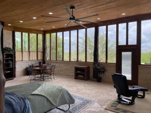 a bedroom with a bed and a ceiling fan at The Cross Patio Retreat in Buda