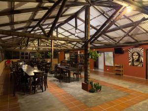 a dining room with tables and chairs and a painting on the wall at Hotel Guaitipan Ancestral in San Agustín