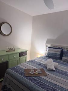 a bedroom with a bed with two cups of coffee on it at Sxm Caribbean Nest in Saint Martin