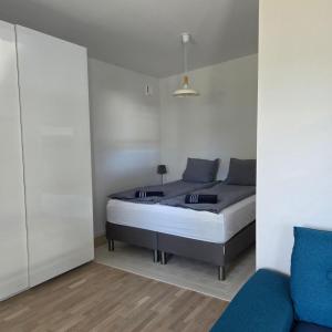 a bedroom with a bed and a couch at Tiny Home in a Tiny Town in Hjärup