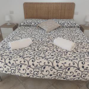 a bed with two pillows on top of it at Lilli's House in Capri in Capri