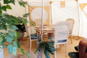 a room with a table and chairs and a tent at Wild Retreat in Cawston