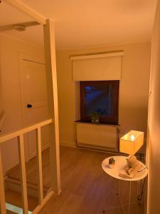 a room with a staircase and a window and a table at Le 8 du Pontois in Ciney +2 photos