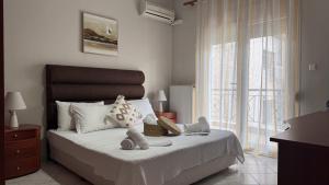 a bedroom with a bed with stuffed animals on it at Complex Summer Memories Souzan in Keramoti