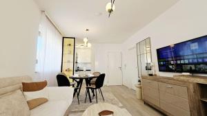 a living room with a white couch and a table at Royal Apartman in Banja Koviljača
