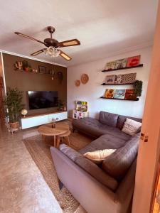 a living room with a couch and a tv at Casa Midu Beachhouse 450m to the Beach in Los Alcázares
