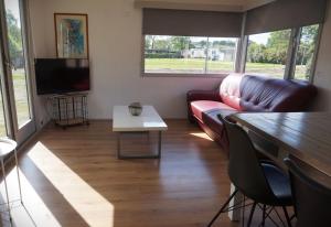 a living room with a couch and a table at 't Veldhuisje 109 - naast het bos, honden toegestaan in Anloo
