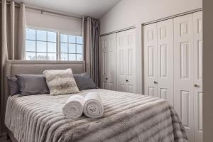 a bedroom with a bed with two towels on it at Charming Luxe Home Sleeps 4 in Anchorage