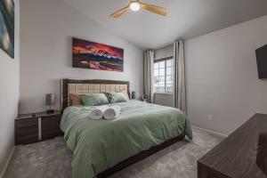 a bedroom with a bed with two towels on it at Charming Luxe Home Sleeps 4 in Anchorage