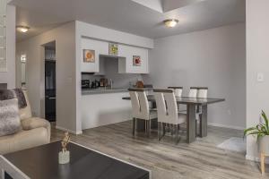 a kitchen and living room with a table and chairs at Charming Luxe Home Sleeps 4 in Anchorage +12 photos