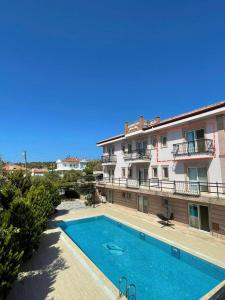 a swimming pool in front of a building at Maison Edina - Cunda in Ayvalık