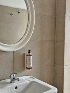 a bathroom with a mirror and a white sink at Hotel Ornella in Bellaria-Igea Marina