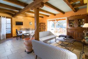 a living room with a couch and a table at Gîte au Couchant à Caylus - Piscine - Jardin - 3 chambres - 8 personnes - 5 minutes du village médiéval in Caylus