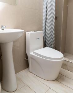 a bathroom with a white toilet and a sink at Gran Estancia Vallecito in Arequipa +25 photos