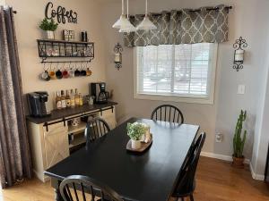 a dining room with a black table and chairs at Lake Melissa Cabin on the Commons in Detroit Lakes