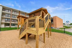 a wooden play structure in front of a building at Serene Creek Condo Pool & Gym in Branson