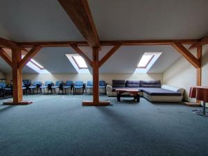 a large room with a couch and chairs in it at City Hotel Siófok in Siófok