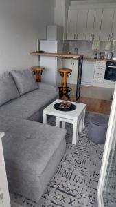 a living room with a couch and a table at Apartman Stan Laktasi in Laktaši +9 photos