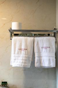 two towels on a towel rack in a bathroom at Lumina Stays-Modern Luxury Rooms, Near NAD in Visakhapatnam +16 photos