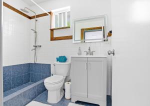 a bathroom with a toilet and a sink and a shower at Slice of Paradise with Private Beach in Agat +33 photos