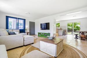 a living room with a couch and a table at Slice of Paradise with Private Beach in Agat