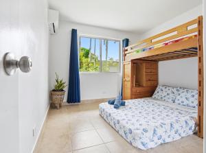 a bedroom with a bunk bed and a window at Slice of Paradise with Private Beach in Agat