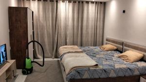a bedroom with a bed and a vacuum at Avenue Alhambra princess resort in Hurghada +81 photos