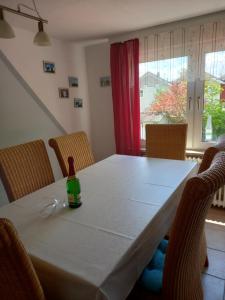 a bottle of wine sitting on a table with chairs at Ferienwohnung Kreider in Dagebüll