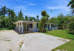a house with a driveway in front of it at Slice of Paradise with Private Beach in Agat