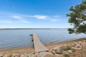 a bench sitting next to a body of water at Amazing Grace Etta Shores in Henning