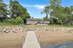 a house on the shore of a beach with a dock at Amazing Grace Etta Shores in Henning